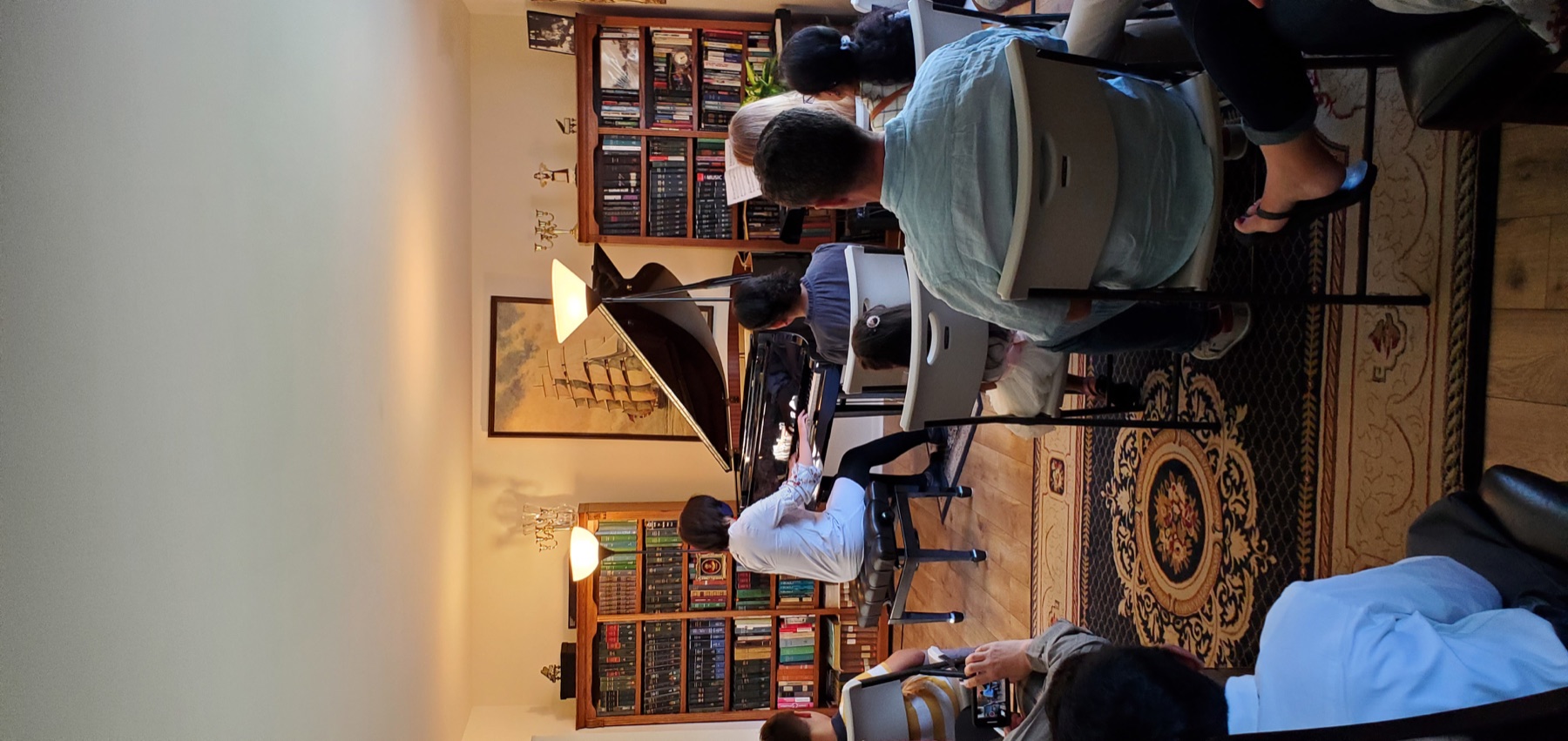 Pianist performing for an audience at a student concert