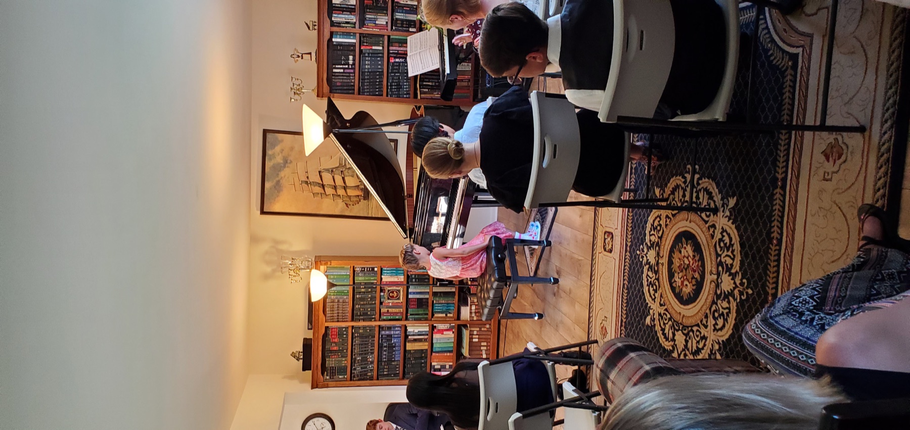 Young pianist seated at the grand piano during a recital