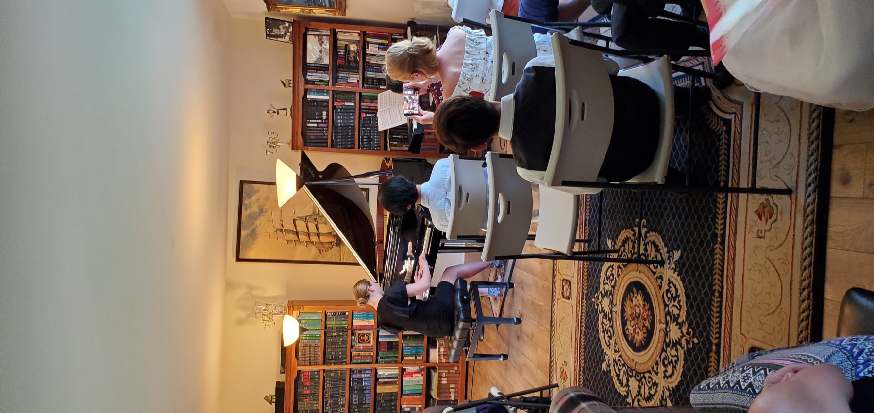 Student in concert attire performing at the piano