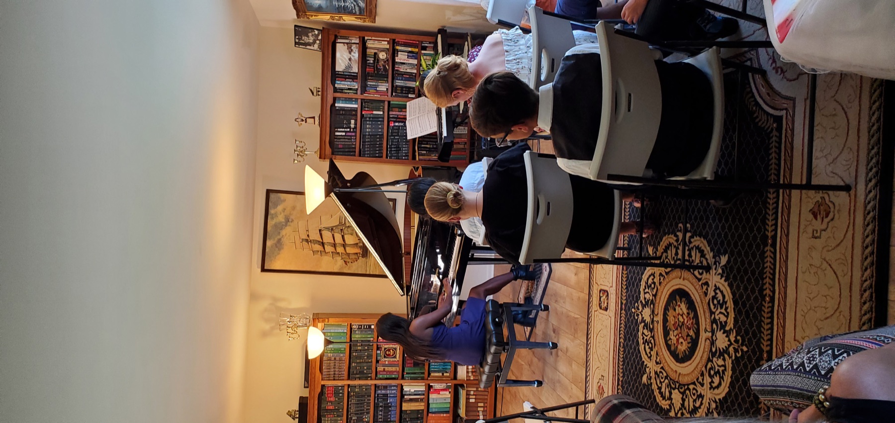 Pianist performing while fellow students and families listen